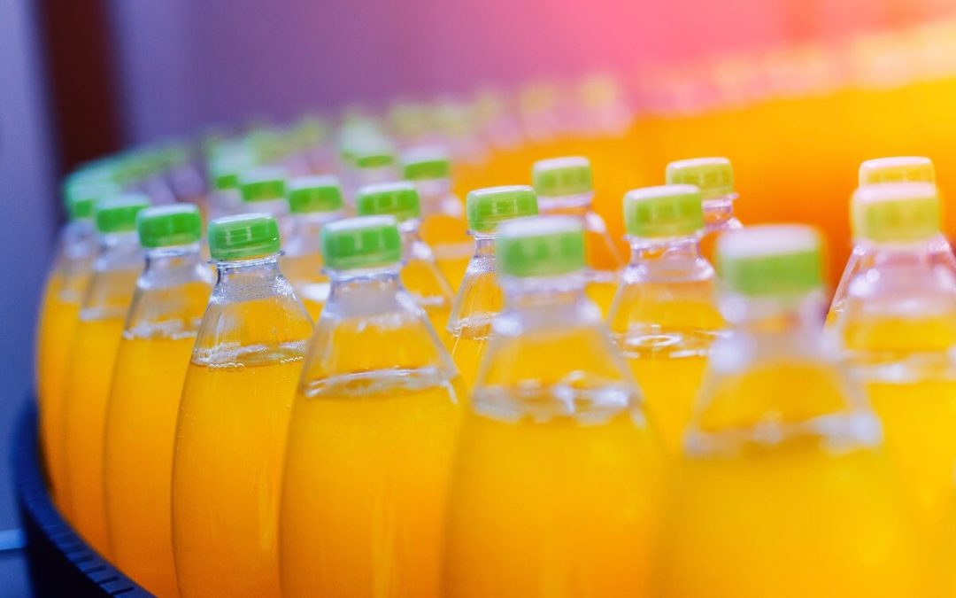 Bottling conveyer belt moving drinks sweetened by honey in manufacturing